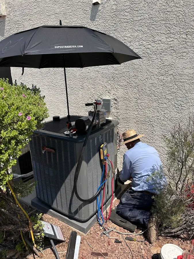 HVAC technician performing outdoor AC maintenance in Collier